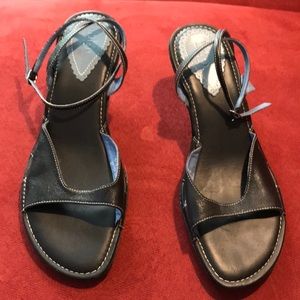 Clark’s indigo strapped black leather sandals